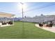 Spacious backyard featuring an outdoor seating area with fire pit and patio under an awning at 119 Cedar St, Henderson, NV 89015