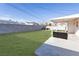 Spacious backyard featuring a lush green lawn, cozy seating area, and brick perimeter at 119 Cedar St, Henderson, NV 89015