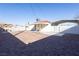The large backyard features gravel, a patio, and a covered area with block wall at 119 Cedar St, Henderson, NV 89015
