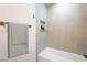 Modern bathroom with sleek grey tiling, niche shelving, and a convenient towel rack at 119 Cedar St, Henderson, NV 89015