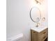 Bathroom featuring a wood vanity, modern fixtures, a round mirror, and decorative lighting at 119 Cedar St, Henderson, NV 89015