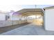 Spacious covered carport with concrete flooring, metal frame and privacy fence at 119 Cedar St, Henderson, NV 89015