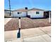 Charming single-story home with white exterior, brown roof, and minimal landscaping at 119 Cedar St, Henderson, NV 89015