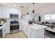 Open-concept kitchen featuring modern appliances and a view to the living and dining area at 119 Cedar St, Henderson, NV 89015