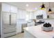 Modern kitchen with stainless steel appliances, white cabinets and quartz countertops at 119 Cedar St, Henderson, NV 89015