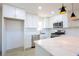 Modern kitchen with white cabinets, stainless steel appliances, and quartz countertops at 119 Cedar St, Henderson, NV 89015