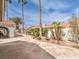 The backyard is tastefully landscaped with mature palm trees and decorative rock and greenery at 1276 Spanish Armada Rd, Las Vegas, NV 89123