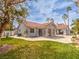 Beautiful backyard with lush green grass and mature landscaping surrounding the home at 1276 Spanish Armada Rd, Las Vegas, NV 89123