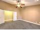 Large carpeted bedroom features a ceiling fan, base trim and neutral paint at 1276 Spanish Armada Rd, Las Vegas, NV 89123