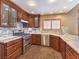 Bright kitchen features wood cabinets, stainless appliances, tile backsplash, and granite countertops at 1276 Spanish Armada Rd, Las Vegas, NV 89123