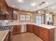 This kitchen has granite countertops, wood cabinets, a view of the living area, and stainless appliances at 1276 Spanish Armada Rd, Las Vegas, NV 89123