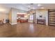 Open-concept living space featuring wood-look flooring, a fireplace, and a view into the kitchen at 1276 Spanish Armada Rd, Las Vegas, NV 89123