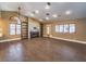 Living area with high ceilings, a fireplace, wood-look flooring, and ample natural light at 1276 Spanish Armada Rd, Las Vegas, NV 89123