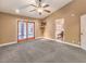 Bright primary bedroom with plush carpet and an ensuite bathroom with a soaking tub at 1276 Spanish Armada Rd, Las Vegas, NV 89123