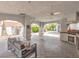 The covered outdoor space offers comfortable seating, a grill and mature landscaping with a view at 1276 Spanish Armada Rd, Las Vegas, NV 89123