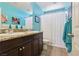 Bright bathroom featuring double sinks with granite counters, tile floors, and ample natural light at 145 Blue Trout Ave, Henderson, NV 89011