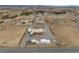 High angle aerial showcasing large lot with outbuildings, landscaping and car port at 1550 Tiptop Trl, Pahrump, NV 89048