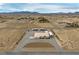 Expansive aerial view of a property with a large lot, desert landscape and mountain backdrop at 1550 Tiptop Trl, Pahrump, NV 89048