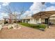 Spacious backyard features a hammock, outdoor dining area, and well-maintained landscaping at 1550 Tiptop Trl, Pahrump, NV 89048