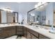 Double sink bathroom with custom cabinets, quartz countertops, and framed mirrors at 1550 Tiptop Trl, Pahrump, NV 89048