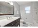 Updated bathroom featuring modern vanity, quartz counters, and a marble tiled shower at 1550 Tiptop Trl, Pahrump, NV 89048