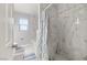 Modern bathroom featuring marble tiled shower and floors, and a soaking tub at 1550 Tiptop Trl, Pahrump, NV 89048