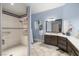 Elegant bathroom featuring a tiled walk-in shower, a vanity, and sleek fixtures at 1550 Tiptop Trl, Pahrump, NV 89048