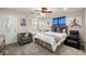 Comfortable bedroom with chair, artwork, and large windows allowing ample natural light at 1550 Tiptop Trl, Pahrump, NV 89048