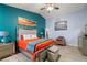 Bright bedroom with eye-catching colorful wall accents, stylish furniture, and decor at 1550 Tiptop Trl, Pahrump, NV 89048