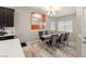 Bright dining room boasts modern light fixture, and a window with natural light at 1550 Tiptop Trl, Pahrump, NV 89048