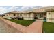 Attractive front yard with brick sidewalk, faux turf, and a cozy outdoor seating area at 1550 Tiptop Trl, Pahrump, NV 89048