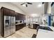 Spacious kitchen with stainless steel appliances and dark cabinets flows into dining area at 1550 Tiptop Trl, Pahrump, NV 89048