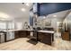 Kitchen features stainless appliances, dark cabinets, quartz countertops and open floor plan at 1550 Tiptop Trl, Pahrump, NV 89048