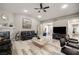 Bright living room featuring modern hardwood flooring, fireplace and lots of seating at 1550 Tiptop Trl, Pahrump, NV 89048