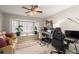 Bright home office with large window, neutral walls, and a comfortable seating area at 1550 Tiptop Trl, Pahrump, NV 89048