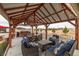 Inviting outdoor dining area with a covered patio, comfortable seating, and views of the surrounding landscape at 1550 Tiptop Trl, Pahrump, NV 89048