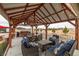 Enjoy this covered outdoor living space with comfortable seating, dining, and built in outdoor kitchen and grill at 1550 Tiptop Trl, Pahrump, NV 89048