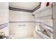 Walk-in shower features tiled walls, bench, and shower head at 1550 Tiptop Trl, Pahrump, NV 89048