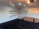 Spacious garage featuring overhead lighting, fan, shelving for storage, and ample open space at 1900 E Highland Ave, Pahrump, NV 89048