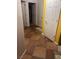 Hallway with neutral colors and tiled flooring provides a bright and calming transition between rooms at 1900 E Highland Ave, Pahrump, NV 89048