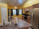 Bright eat-in kitchen with wooden cabinets, stainless appliances, and plenty of natural light at 1900 E Highland Ave, Pahrump, NV 89048