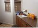 Laundry room with a sink, cabinetry, and two small windows at 1900 E Highland Ave, Pahrump, NV 89048