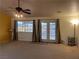 Bright living room featuring a large window and glass doors opening to the backyard at 1900 E Highland Ave, Pahrump, NV 89048