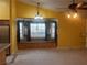 Inviting living room with a charming window seat, large window, and decorative light fixture at 1900 E Highland Ave, Pahrump, NV 89048