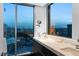 Contemporary bathroom offers dual sinks, marble countertops, and a large window with city views at 2700 Las Vegas Blvd # 4306, Las Vegas, NV 89109