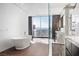 Modern bathroom featuring a soaking tub, glass-enclosed shower, and stunning city views at 2700 Las Vegas Blvd # 4306, Las Vegas, NV 89109