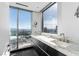 Modern bathroom features dual sinks, marble countertops, and a large window with city views at 2700 Las Vegas Blvd # 4306, Las Vegas, NV 89109