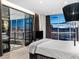 Modern bedroom with floor-to-ceiling windows offers stunning city views, complemented by sleek decor and balcony access at 2700 Las Vegas Blvd # 4306, Las Vegas, NV 89109