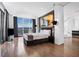 Spacious main bedroom featuring hardwood floors, city views, modern lighting, and an ensuite bathroom at 2700 Las Vegas Blvd # 4306, Las Vegas, NV 89109