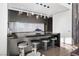 Stylish kitchen island with seating, modern lighting, and sleek gray cabinets and counters at 2700 Las Vegas Blvd # 4306, Las Vegas, NV 89109